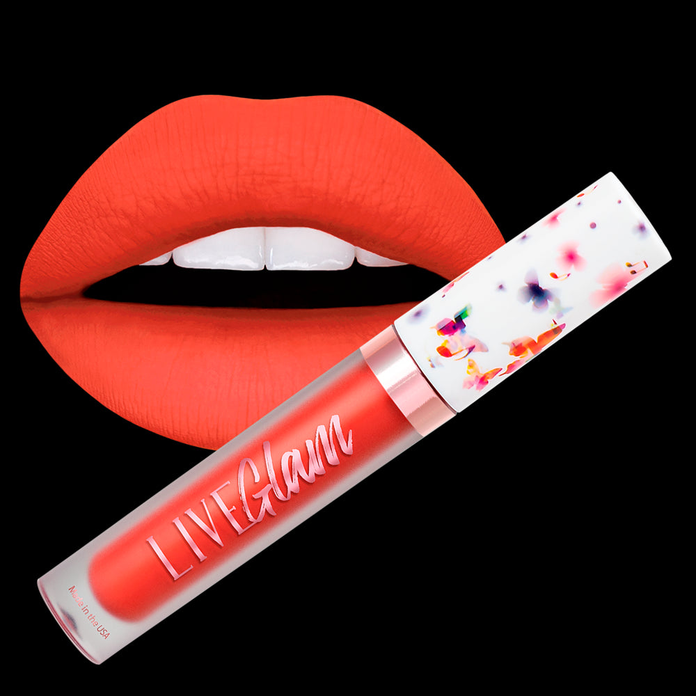 A close-up image of the LiveGlam red-orange matte liquid lippie 'Rose Over Bros' with the butterfly-music cap; imposed over a set of lips painted with 'Rose Over Bros' matte liquid lippie